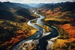 Amidst the vibrant colors of autumn, a braided river flows through a majestic valley surrounded by towering mountains, showcasing the beauty and power of nature's water resources