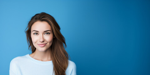 Wall Mural - Young woman over blue wall smiling