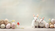 Two rabbits and easter eggs in this easter arrangement on bright background as background or wallpaper