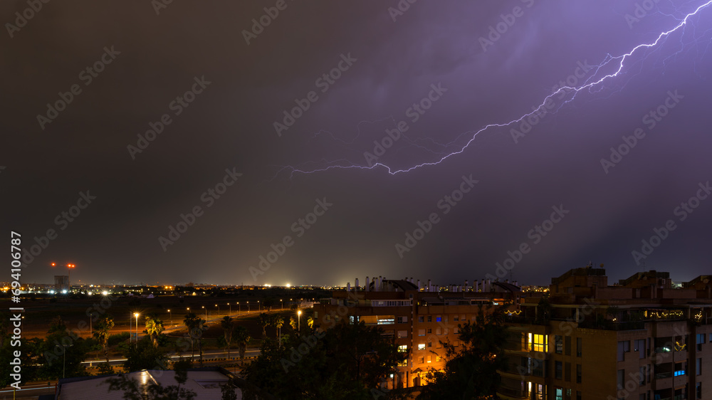 Stormy sky raining with a huge lightning bolt drawing a diagonal in the ...