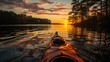 View from a kayak on a tranquil lake during a serene sunset, reflecting the vivid colors on rippled water.