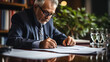 © Pavel - Senior businessman in glasses focusing on signing documents at his office desk, reflecting concentration and professionalism.