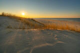 Fototapeta  - Zachód słońca na wydmach na plaży nad morzem oceanem