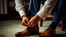 A Man In A Business Suit Ties The Laces, Groom Tying Shoes Getting Ready In The Morning For The Wedding Ceremony.