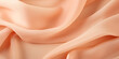 A close up of a peach colored fabric. Monochrome peach fuzz background.