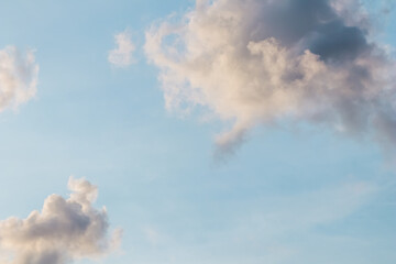 Wall Mural - blue sky background with pale pink clouds at sunset