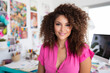 © Keitma - Portrait of a creative designer mixed raced woman with long curly hair as a graphic designer in a white chic office with colorful sticky notes in the background