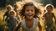 A jubilant young girl with tousled hair joyously leads a group of children in a playful dash through a sunlit field. Her hair flies wildly around her, capturing the energy and movement of the moment.