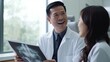 © somchai20162516 - Asian Chinese male dentist explains x-ray to patient