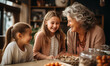 Cheerful grandma and grandkids girl talking, laughing, enjoying family leisure