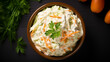 Freshly shredded white cabbage and grated carrot coleslaw topped with homemade mayonnaise dressing, photographed from above