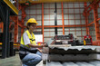 Female factory worker using digital tablet checking galvanized or metal sheet in warehouse storage. Female worker working checking metalwork sheet in warehouse during manufacturing process in plant