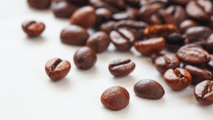 Poster - roasted coffee beans close-up on a white background