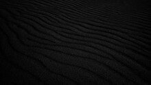 Black Sand Dune. Black Sand Beach Macro Photography. Background, Texture, Wave Pattern Of Oceanic Sand On The Beach, Black. Texture Of Beach Sand. Black Beach.