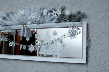 Wall Mural - A mirror decorated with a garland and a reflection of a Christmas tree	