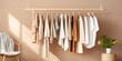 Fashion stylist curates essential wardrobe with neutral colors and wooden hangers.