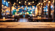 © adynue - Empty wooden table top with lights bokeh on blur restaurant background