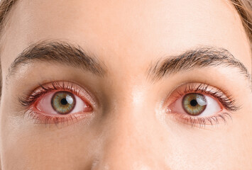 Young woman with beautiful hazel eyes on white background, closeup