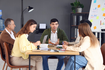 Wall Mural - Group of business people working at table in office