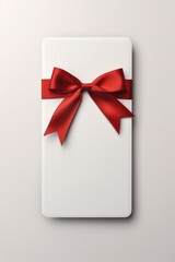 Poster - A white gift box with a vibrant red bow. Perfect for special occasions and gift-giving