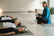 Children relax lying down to the sounds of a Tibetan bowl in the fitness room. Children's yoga