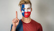 A man with a Texas flag painted on his face proclaims number one