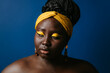 © gstockstudio - Portrait of confident plus size African woman with beautiful make-up and standing on blue background