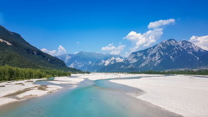 Scenic view of braided river Tagliamento running through mountainous landscape with in Friuli-Venezia Giulia, Italy, Europe. Clear blue water flowing in natural wilderness. Peaceful serene scene