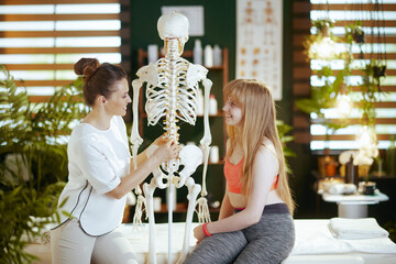 Wall Mural - happy female medical massage therapist in massage cabinet