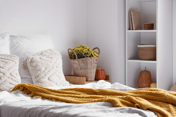 Poster - Interior of cozy bedroom with chrysanthemum flowers and pumpkins