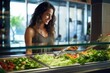 female picking food from a salad bar
