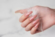 © Olena Rudo - Female hands with pink nail design  hold a feather