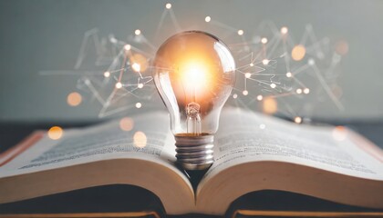 Wall Mural -  light bulb glowing on book, idea of ​​inspiration from reading, innovation idea concept, Self learning or education knowledge and business studying concept