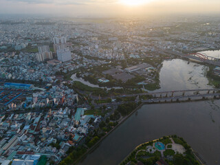 Panoramic view of Saigon, Vietnam from above at Ho Chi Minh City's central business district. Cityscape and many buildings, local houses, bridges, rivers