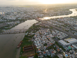 Wall Mural - Panoramic view of Saigon, Vietnam from above at Ho Chi Minh City's central business district. Cityscape and many buildings, local houses, bridges, rivers