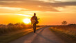 Young man with a guitar on his back walking towards a sunset.