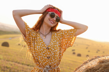 Poster - Portrait of beautiful happy hippie woman in field