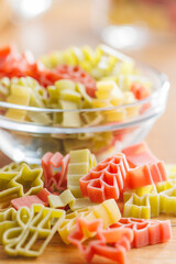 Wall Mural - Uncooked raw pasta. Various Christmas shapes. Pasta on wooden table.