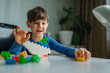 © Westend61 - Happy boy playing with toy blocks at home