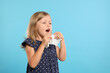 © New Africa - Suffering from allergy. Little girl with tissue sneezing on light blue background, space for text