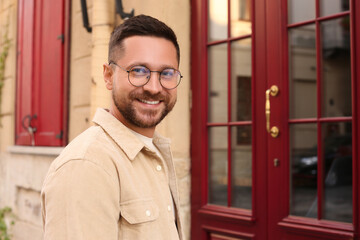 Poster - Portrait of handsome bearded man in glasses outdoors, space for text