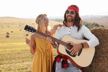 Sticker - Beautiful hippie woman listening to her friend playing guitar in field