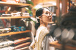 Asian stylish woman in vintage cloth shop purchase new fashion