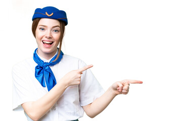 Wall Mural - Airplane stewardess over isolated chroma key background surprised and pointing side