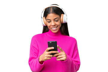 Wall Mural - Young African American woman over isolated background listening music and looking to mobile