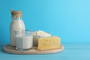 Wall Mural - Lactose free dairy products on light blue wooden table, space for text