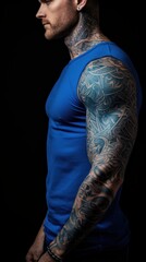 Canvas Print - A man with a tattooed arm and blue shirt standing, AI