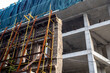 © Grispb - Building under construction. Erection residential complex. Process installing facade on monolithic building. Building business. Architectural industry. Construction residential skyscraper