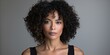 © Andrii Zastrozhnov - A young African American woman with curly hair showcases beauty and confidence in a stylish portrait.
