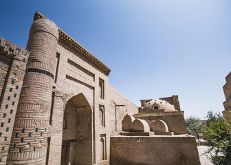 Entrance gate to an ancient brick mosque in the ancient city of Khiva in Khorezm, medieval architecture